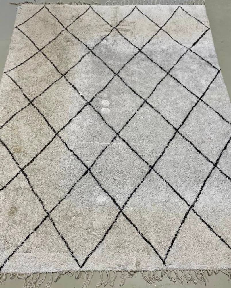 High-pile rug before cleaning — pile flattened